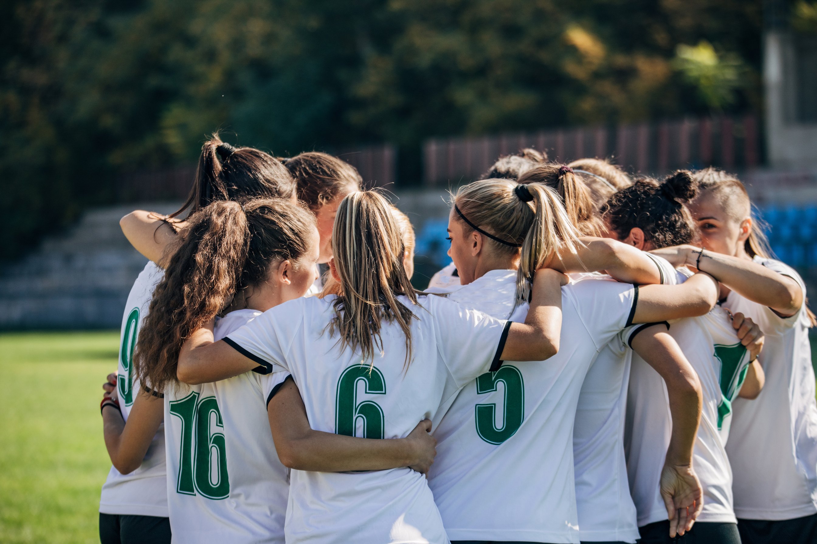 Women soccer team celebrating victory